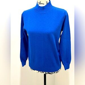 NWOT vibrant Blue Long Sleeve Sweater. Never worn. Size is L but runs like M-L